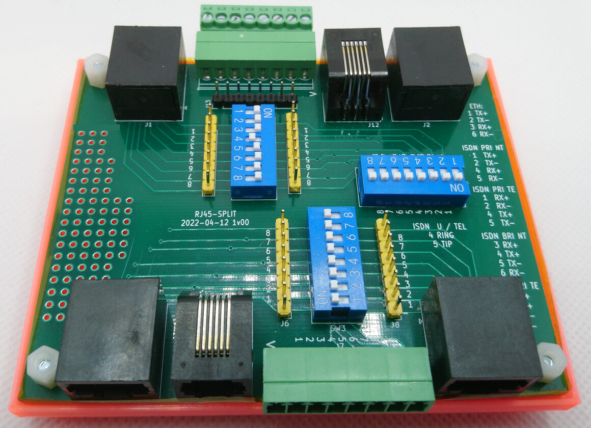 Image of a PCB with RJ45 and RJ12 connectors in an orange 3D printed case